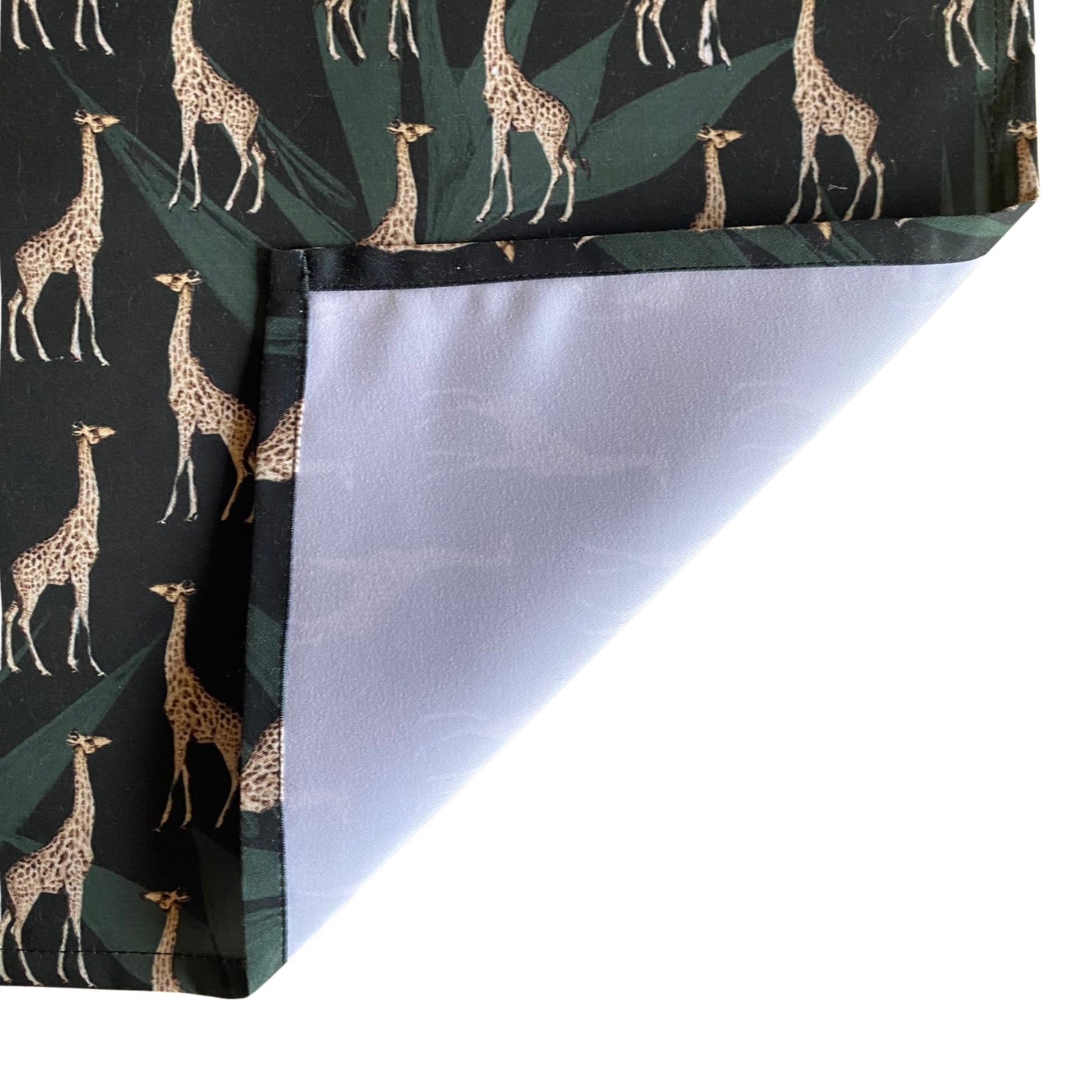Table runner with giraffe pattern on a black background