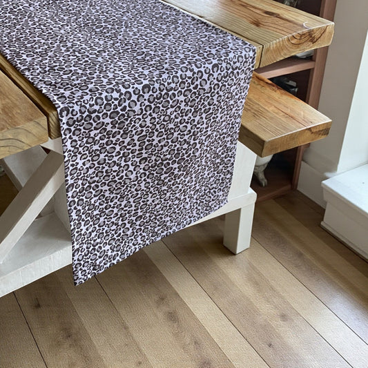 Leopard print table runner on a wooden table