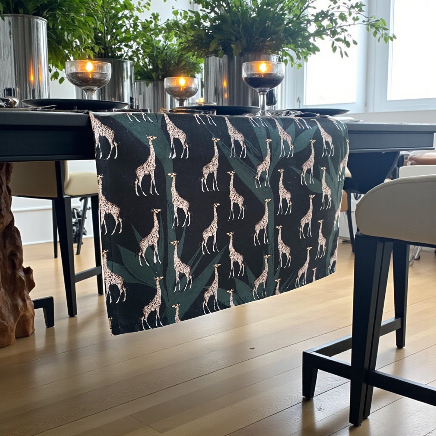 Table runner with a giraffe patterned tablecloth in a well-lit room.