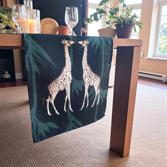 Table with a decorative tablecloth featuring giraffe designs in a home setting.
