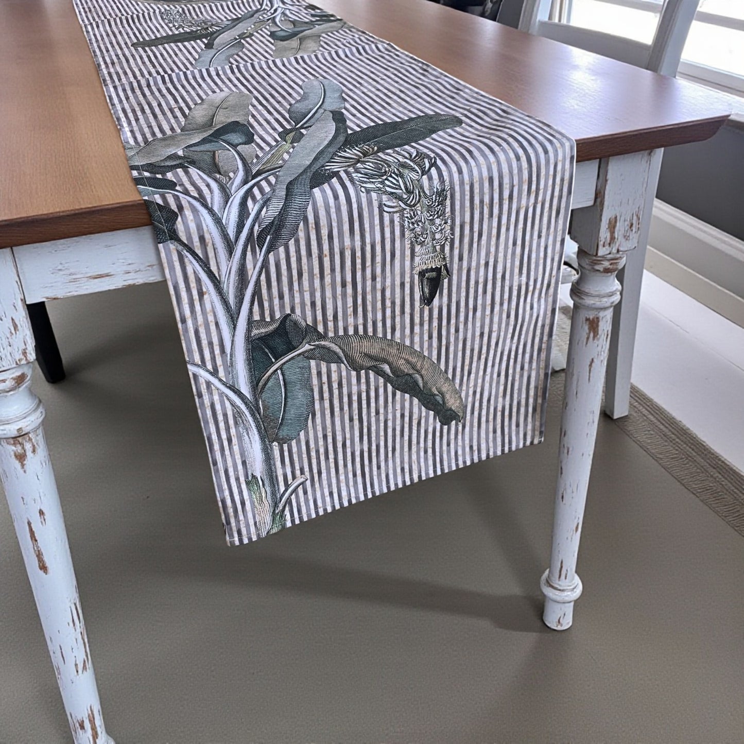Table runner with nature-themed design on a wooden table